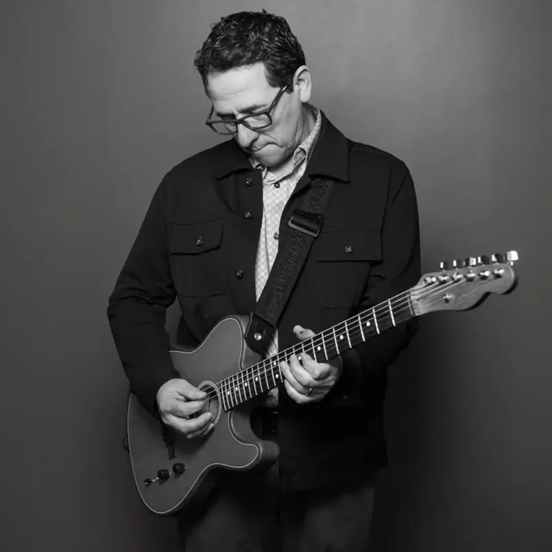 Rick Lozano holding a guitar